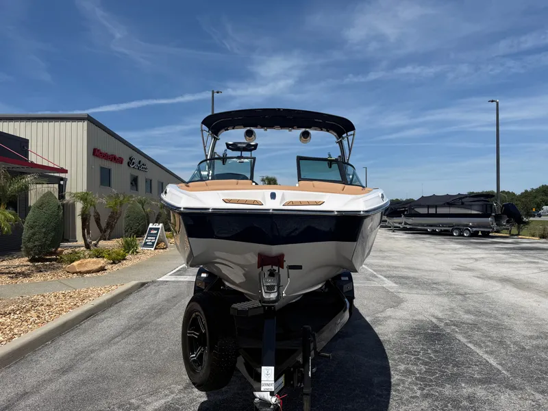 Slide: The Image of 2022 MasterCraft XT22 boat on a trailer in front of a building. - 3
