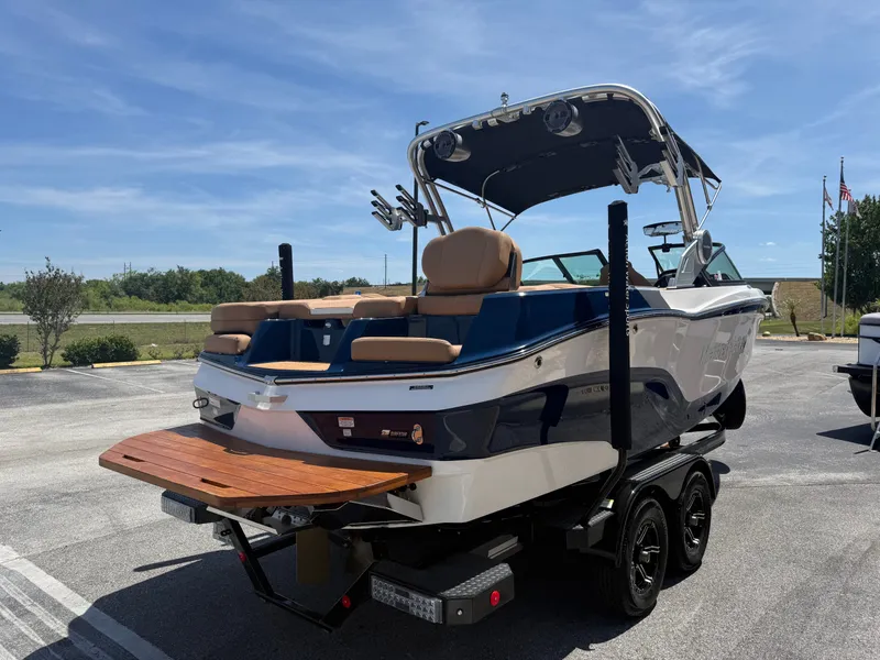 Slide: The Image of 2022 MasterCraft XT22 boat on trailer in sunny weather. - 6