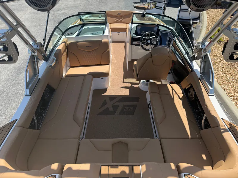 Slide: The Image of Interior of a 2022 MasterCraft XT22 boat with brown seating. - 9
