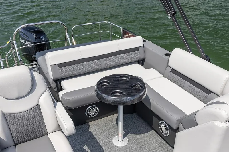 Slide: The Image of Manufacturer Provided Image: 2023 Godfrey SWEETWATER 2486 SFL boat interior with seating and table on water. - 11
