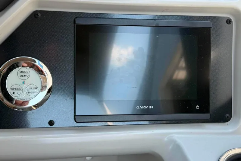 Slide: The Image of Garmin display and control panel on 2023 Godfrey Sweetwater 2486 SFL boat. - 17