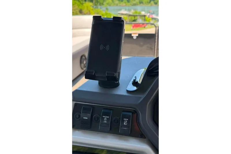 Slide: The Image of Control panel of 2023 Godfrey Sweetwater 2486 SFL boat with phone holder and switches. - 18