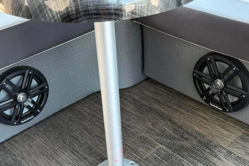 Slide: The Image of 2023 Godfrey Sweetwater 2486 SFL interior with speakers and table base. - 24