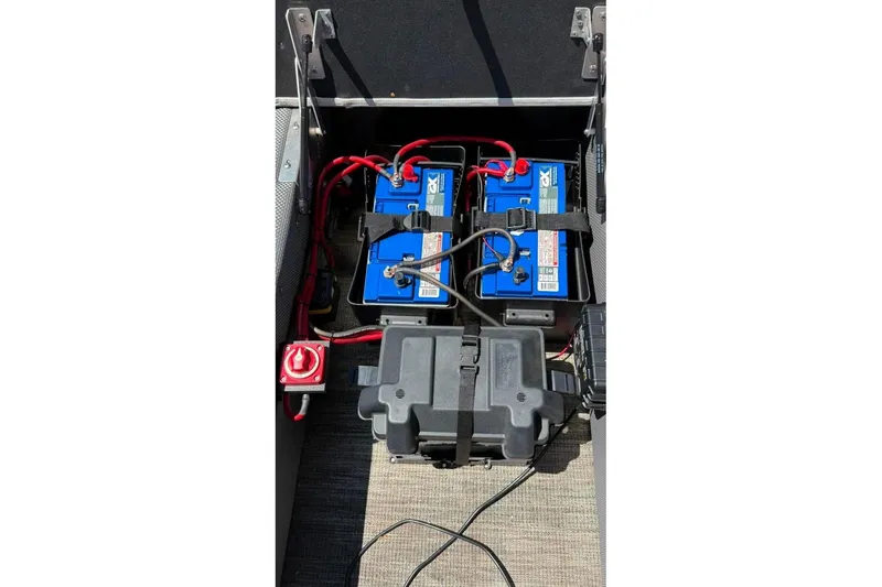 Slide: The Image of Battery compartment of 2023 Godfrey Sweetwater 2486 SFL pontoon boat with wiring and connections. - 27