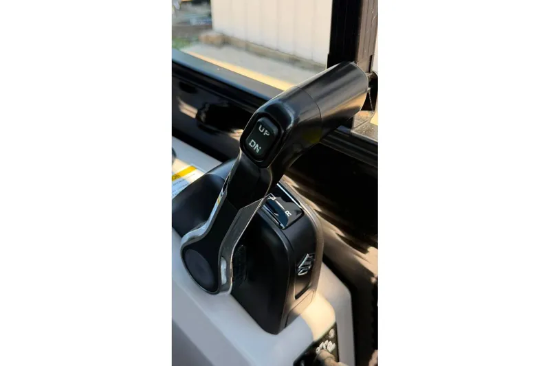 Slide: The Image of Throttle control lever on 2023 Godfrey Sweetwater 2486 SFL boat, featuring "UP" and "DN" buttons. - 31