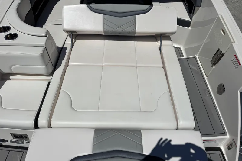 Slide: The Image of 2021 Chaparral 287 SSX boat interior with white seating and cup holders. - 12