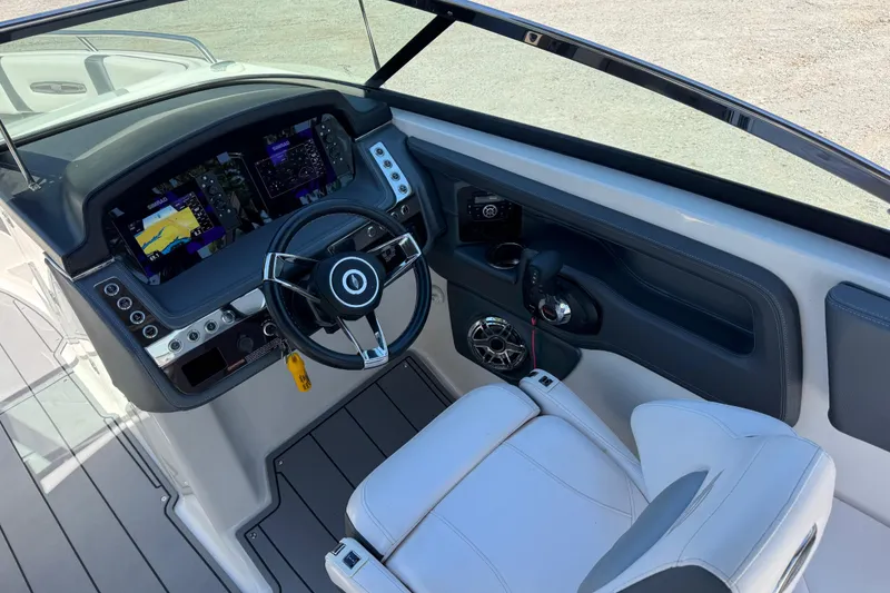 Slide: The Image of Cockpit of 2021 Chaparral 287 SSX boat with modern steering and navigation displays. - 7