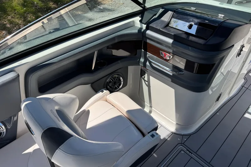 Slide: The Image of 2021 Chaparral 287 SSX boat interior with sleek seating and modern dashboard design. - 8