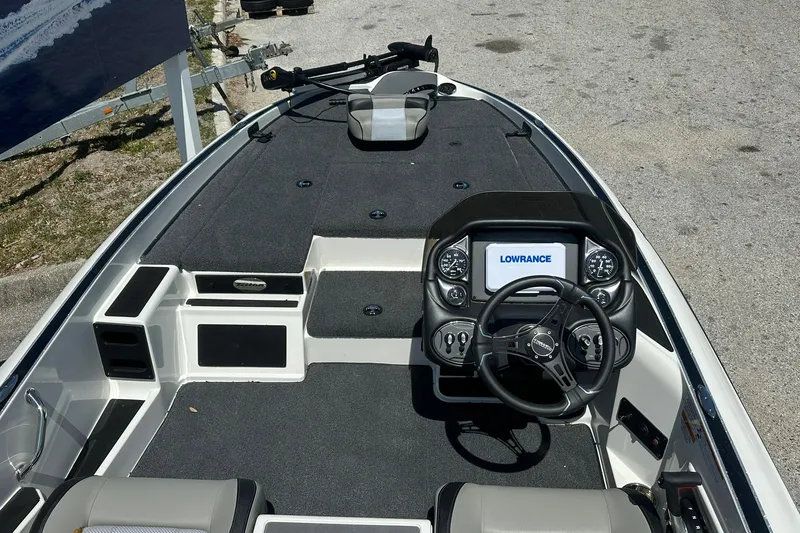 Slide: The Image of 2026 Triton 179 TrX boat interior with steering wheel and Lowrance display. - 11