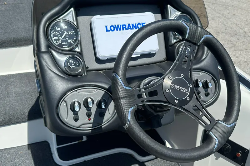 Slide: The Image of Steering console of 2026 Triton 179 TrX boat with Lowrance display and gauges. - 14