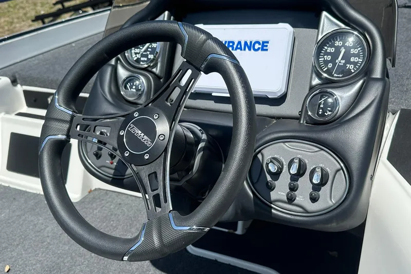 Slide: The Image of 2026 Triton 179 TrX boat dashboard with steering wheel and gauges. - 15