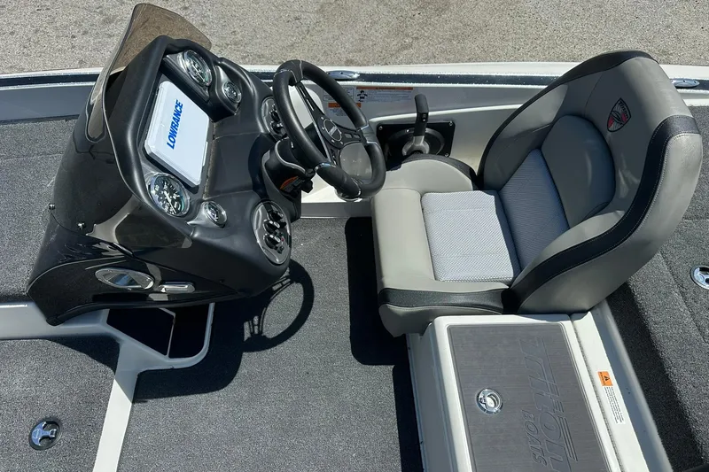 Slide: The Image of 2026 Triton 179 TrX boat cockpit with steering wheel, gauges, and comfortable seating. - 16