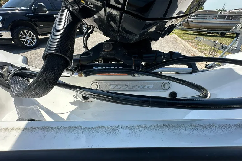 Slide: The Image of 2026 Triton 179 TrX boat engine detail with visible cables and components. - 25