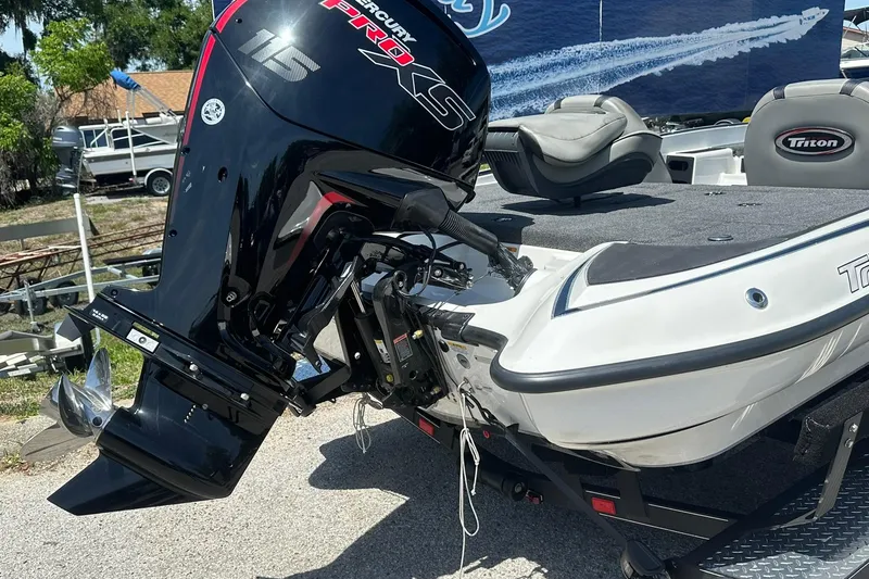 Slide: The Image of 2026 Triton 179 TrX boat with Mercury Pro XS 115 outboard motor, parked on trailer. - 28