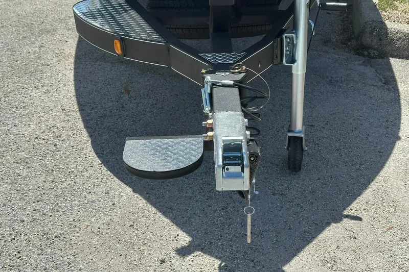 Slide: The Image of Trailer hitch of 2026 Triton 179 TrX boat on pavement. - 3