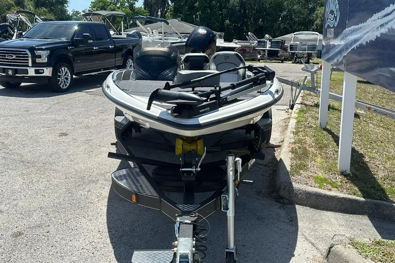 Slide: The Image of 2026 Triton 179 TrX boat on trailer, parked beside a black truck. - 4