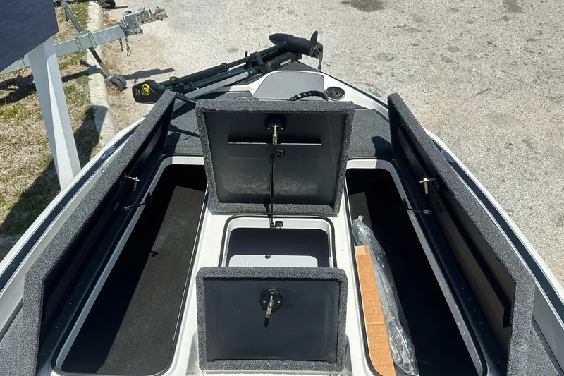 Slide: The Image of 2026 Triton 179 TrX boat storage compartments open, showcasing ample space and organization. - 6