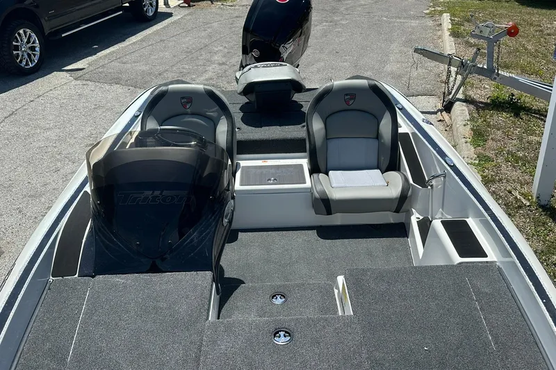 Slide: The Image of 2026 Triton 179 TrX boat interior with dual seats and carpeted flooring. - 9
