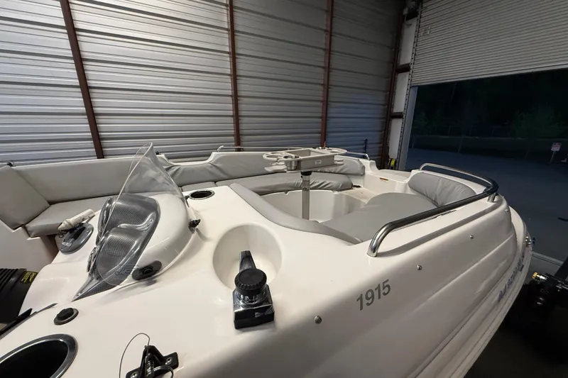 Slide: The Image of 2014 Starcraft 1915 OB Limited boat in storage, featuring sleek design and comfortable seating. - 13