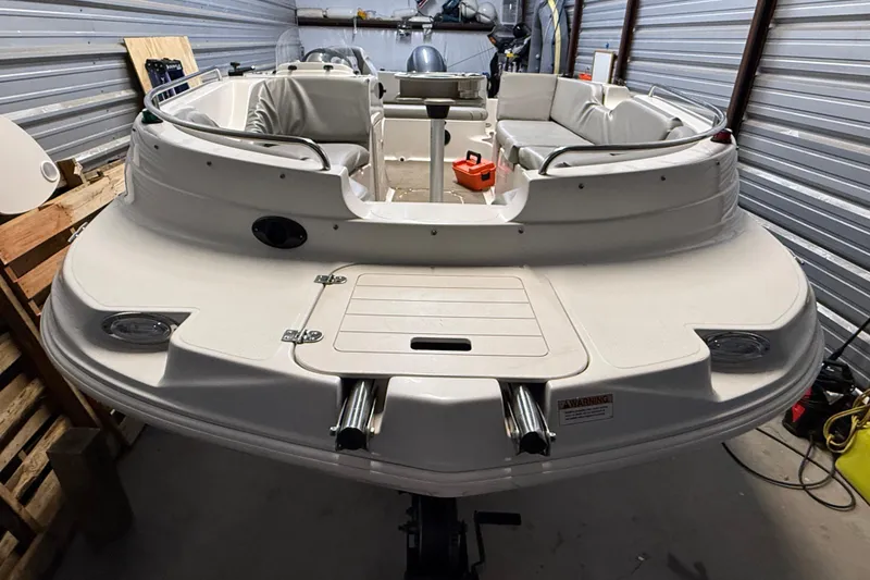 Slide: The Image of 2014 Starcraft 1915 OB Limited boat in storage, featuring spacious seating and sleek design. - 2