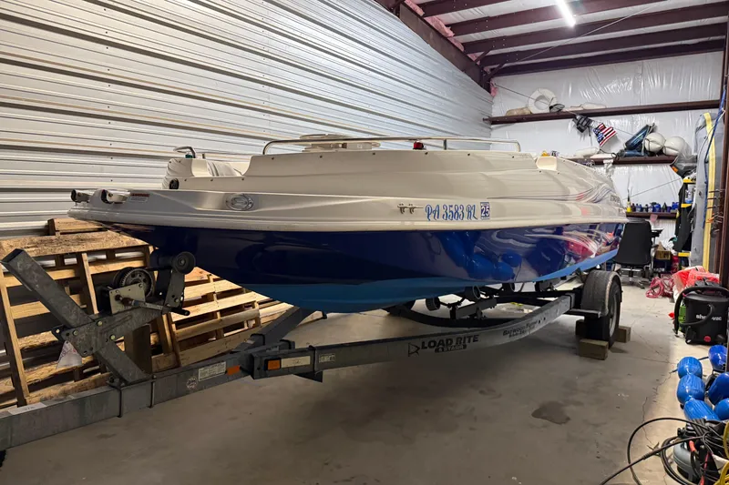 Slide: The Image of 2014 Starcraft 1915 OB Limited boat on trailer in a storage facility. - 5