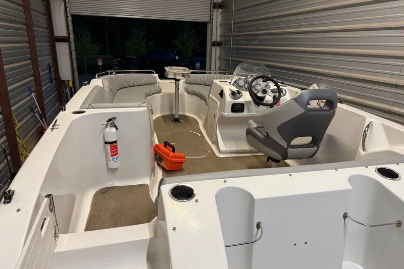 Slide: The Image of 2014 Starcraft 1915 OB Limited boat interior with seating, steering console, and safety equipment. - 6