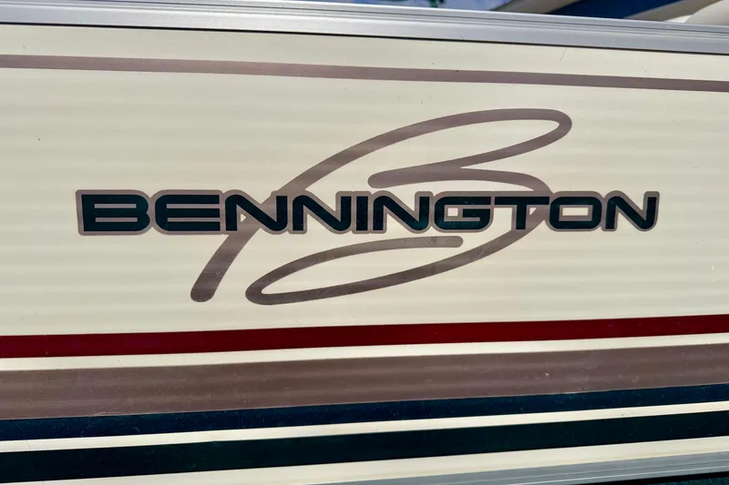 Slide: The Image of Bennington 2050 LX 2001 logo on boat exterior with red and blue stripes. - 13