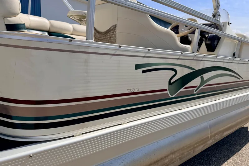 Slide: The Image of 2001 Bennington 2050 LX pontoon boat with stylish side graphics and comfortable seating. - 15