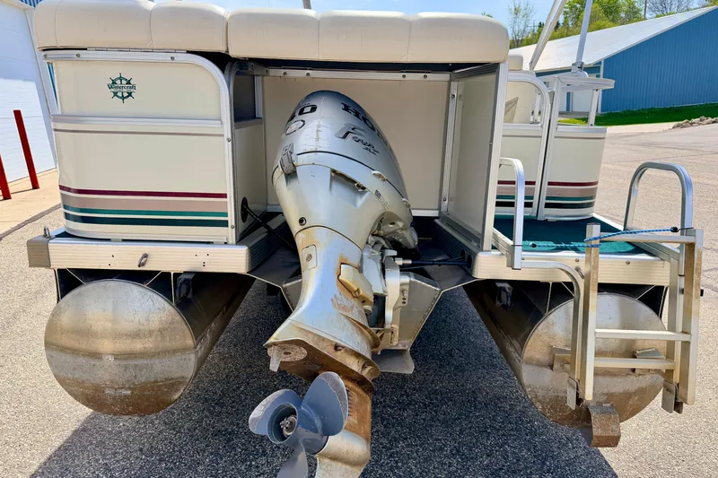 Slide: The Image of 2001 Bennington 2050 LX pontoon boat with outboard motor, docked on pavement. - 21