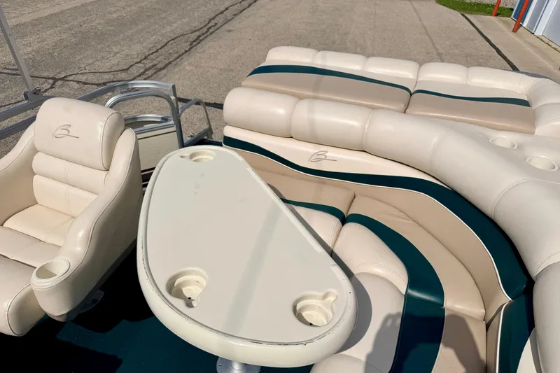 Slide: The Image of Interior of a 2001 Bennington 2050 LX boat with beige seating and table. - 22