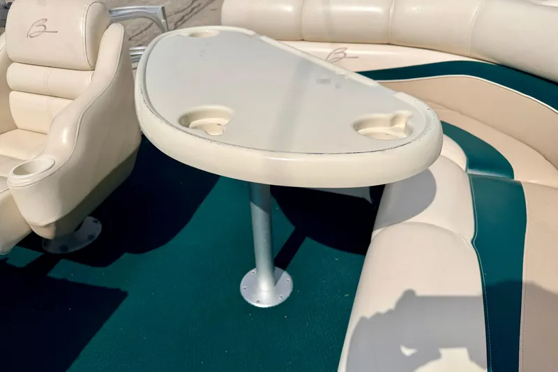 Slide: The Image of Interior of a 2001 Bennington 2050 LX boat with seating and table. - 23