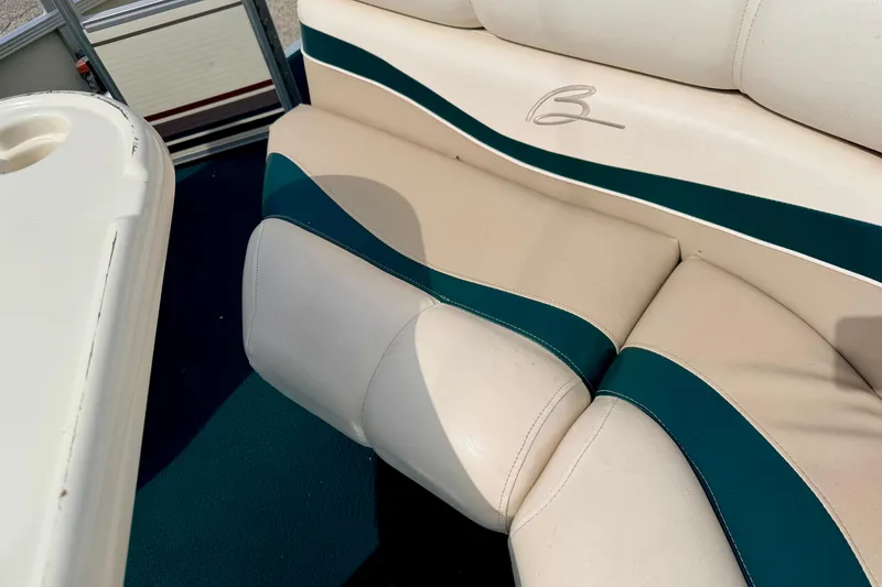 Slide: The Image of Bennington 2050 LX 2001 boat interior with beige and teal seating. - 26
