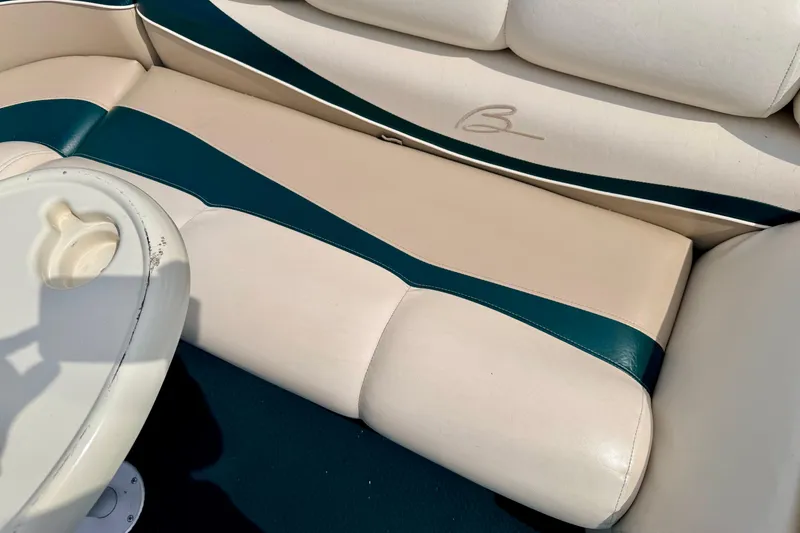 Slide: The Image of Cream and teal seating on a 2001 Bennington 2050 LX boat with table. - 30