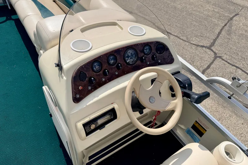 Slide: The Image of Steering console of a 2001 Bennington 2050 LX boat with gauges and controls. - 36