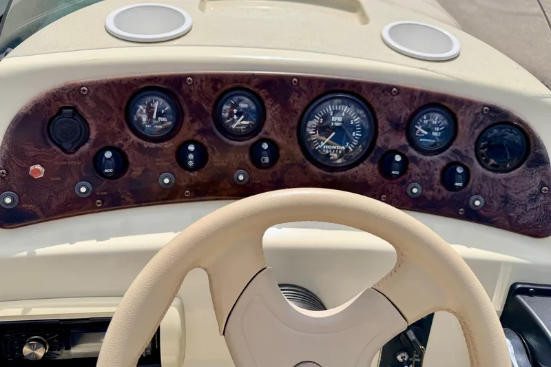 Slide: The Image of Dashboard of a 2001 Bennington 2050 LX boat with gauges and steering wheel. - 37