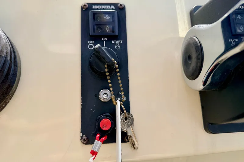 Slide: The Image of Close-up of a Honda ignition panel with keys on a 2001 Bennington 2050 LX boat. - 42
