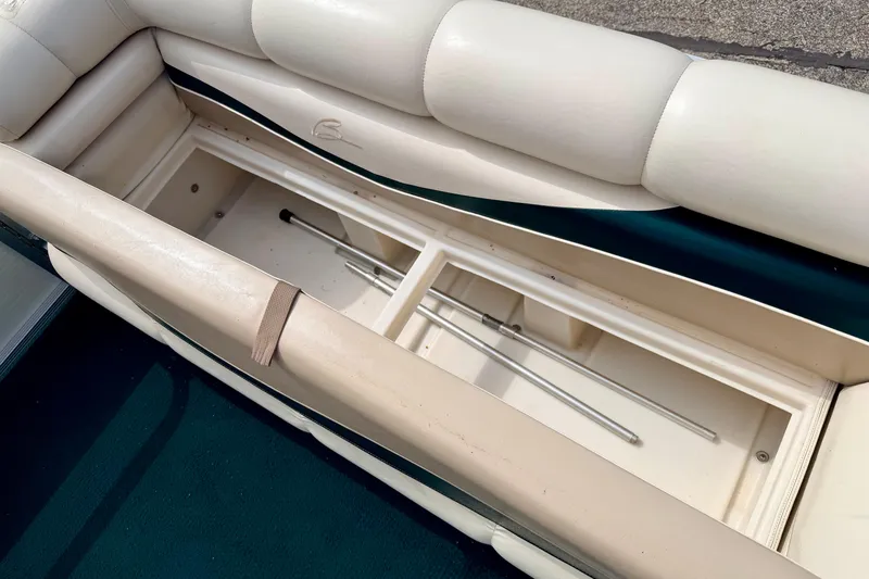 Slide: The Image of Interior storage compartment of a 2001 Bennington 2050 LX boat, featuring cushioned seating. - 48