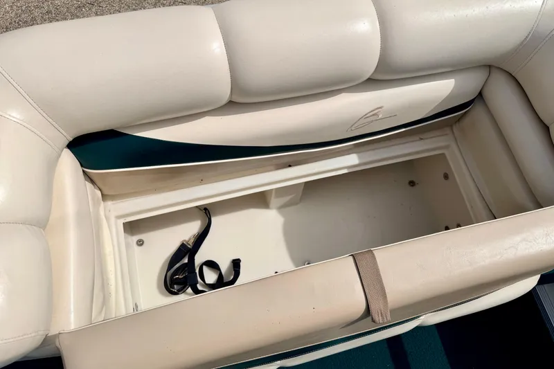 Slide: The Image of Open storage compartment in a 2001 Bennington 2050 LX boat with beige seating. - 50