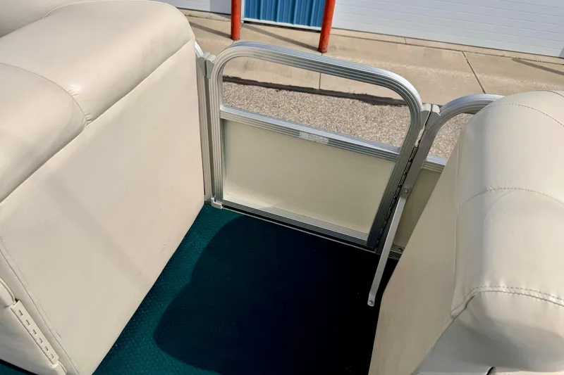 Slide: The Image of Interior view of a 2001 Bennington 2050 LX pontoon boat with beige seating. - 51