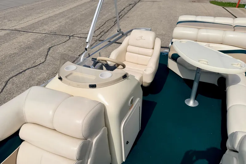 Slide: The Image of 2001 Bennington 2050 LX boat interior with beige seating and steering console. - 52