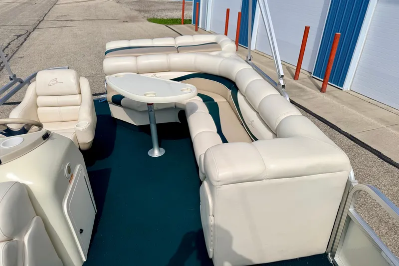 Slide: The Image of 2001 Bennington 2050 LX pontoon boat with white seating and a small table. - 53