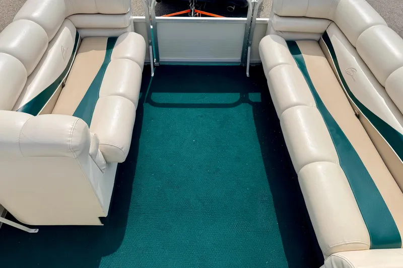 Slide: The Image of Interior of a 2001 Bennington 2050 LX boat with beige and green seating. - 54