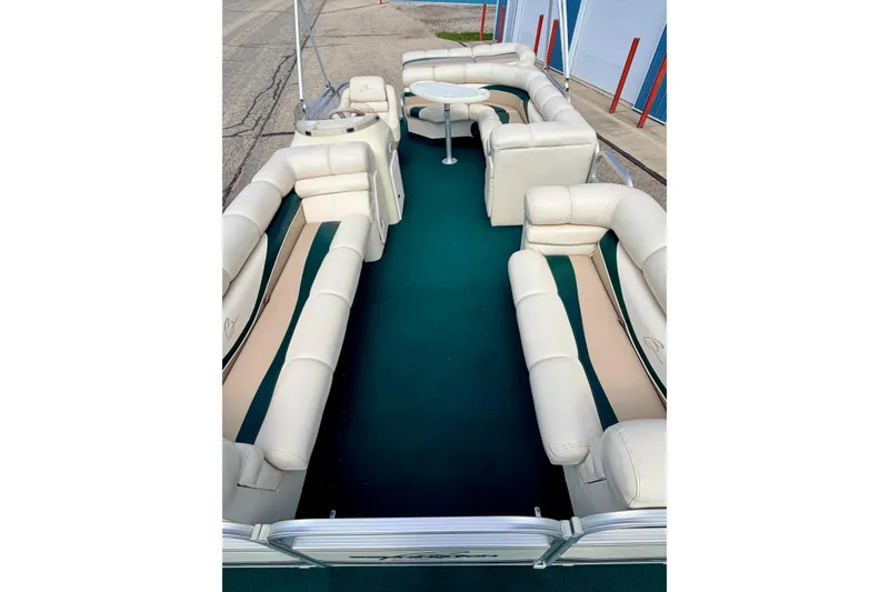 Slide: The Image of 2001 Bennington 2050 LX pontoon boat with spacious seating and green carpeted deck. - 55