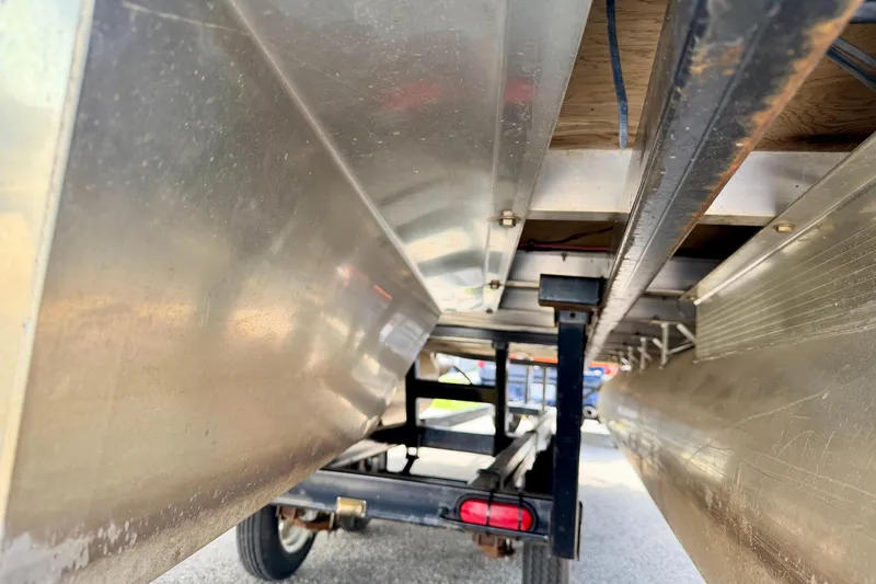 Slide: The Image of Underneath view of a 2001 Bennington 2050 LX pontoon boat on a trailer. - 62