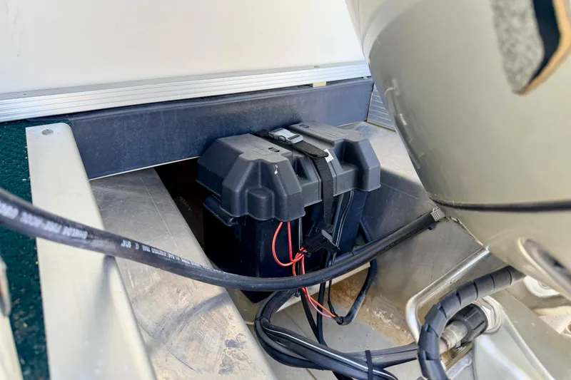 Slide: The Image of Battery compartment of a 2001 Bennington 2050 LX boat, showing wiring and secure placement. - 63
