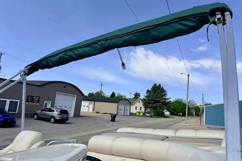 Slide: The Image of 2001 Bennington 2050 LX pontoon boat with green canopy in a parking lot. - 67