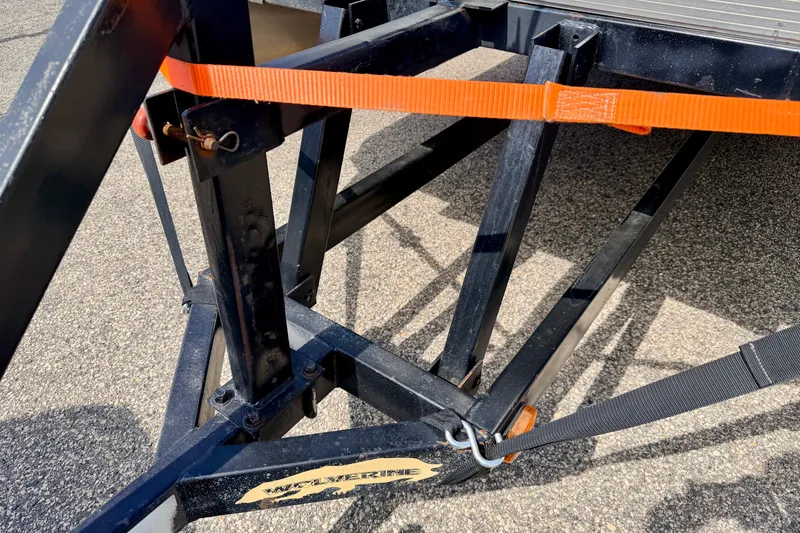Slide: The Image of Trailer hitch with orange strap securing a Bennington 2050 LX, 2001 model. - 70