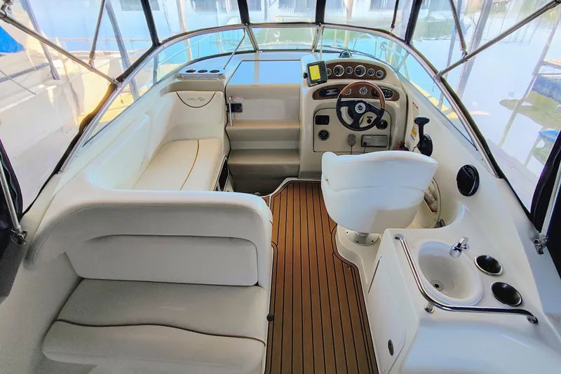 Slide: The Image of Interior of a 2001 Sea Ray Sundancer 260 with helm and seating area. - 12