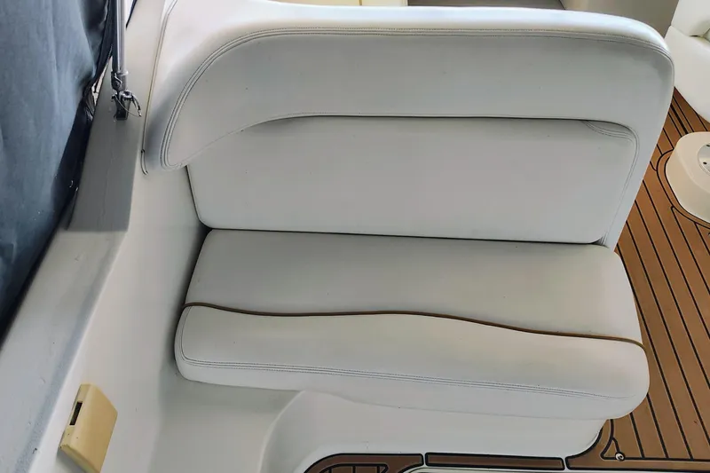 Slide: The Image of White leather seating on 2001 Sea Ray Sundancer 260 boat, with teak flooring. - 25