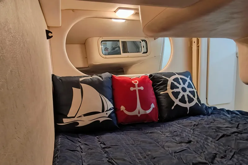 Slide: The Image of Cozy cabin interior of 2001 Sea Ray Sundancer 260 with nautical-themed pillows. - 37